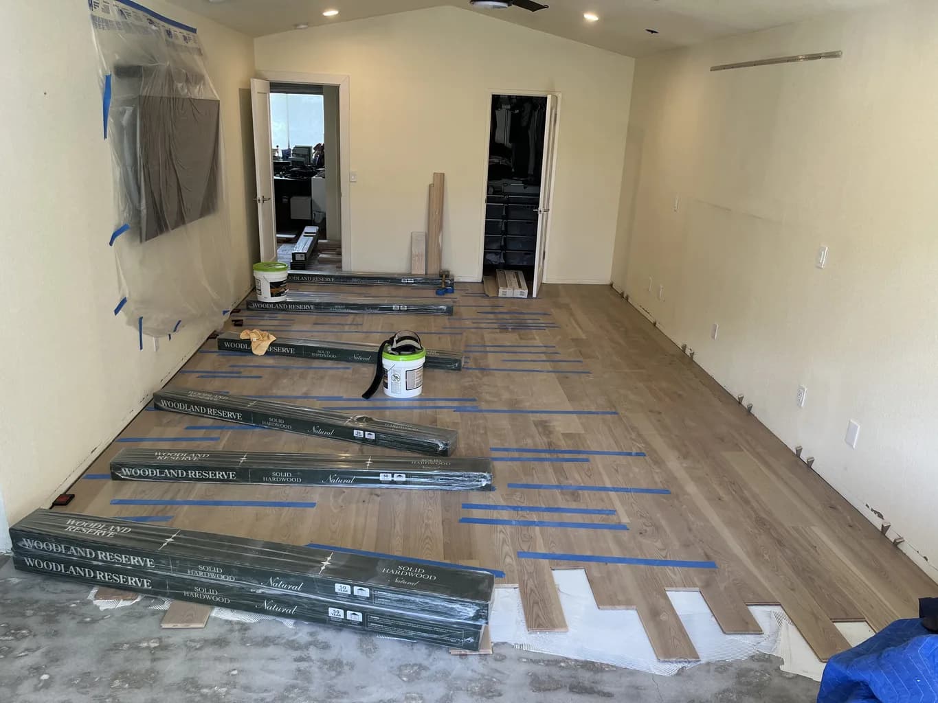 Hardwood installation in progress, planks racked across a prepared subfloor